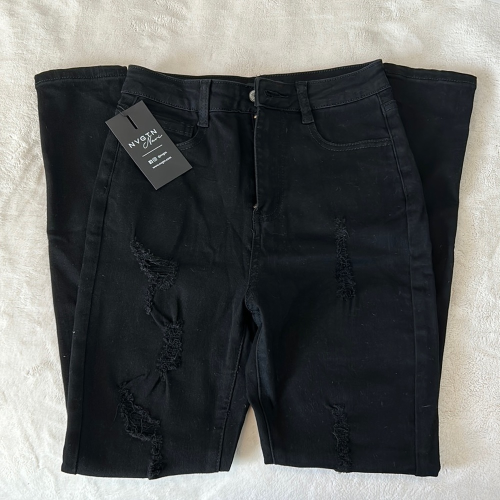 NVGTN black ripped jeans.